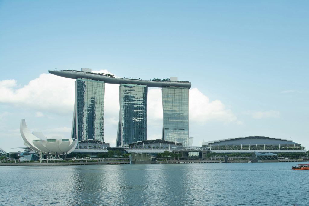 A scenic view of Marina Bay Sands and the Artscience Museum in Singapore against a clear sky.