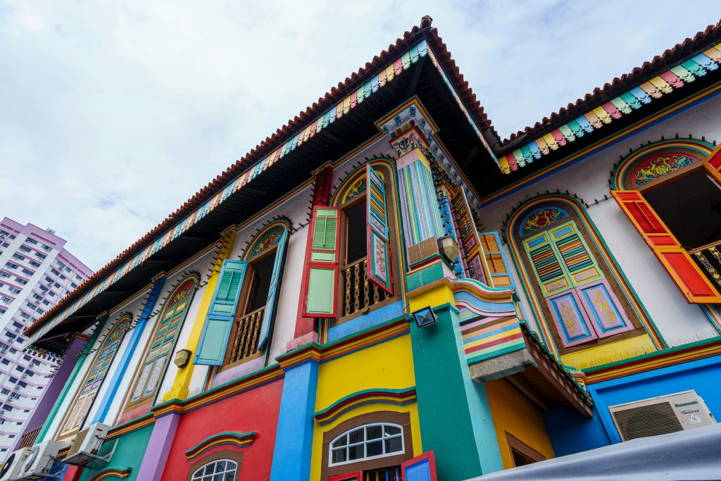 Colorful traditional house in Singapore's Little India, showcasing vibrant architecture with ornate window shutters.