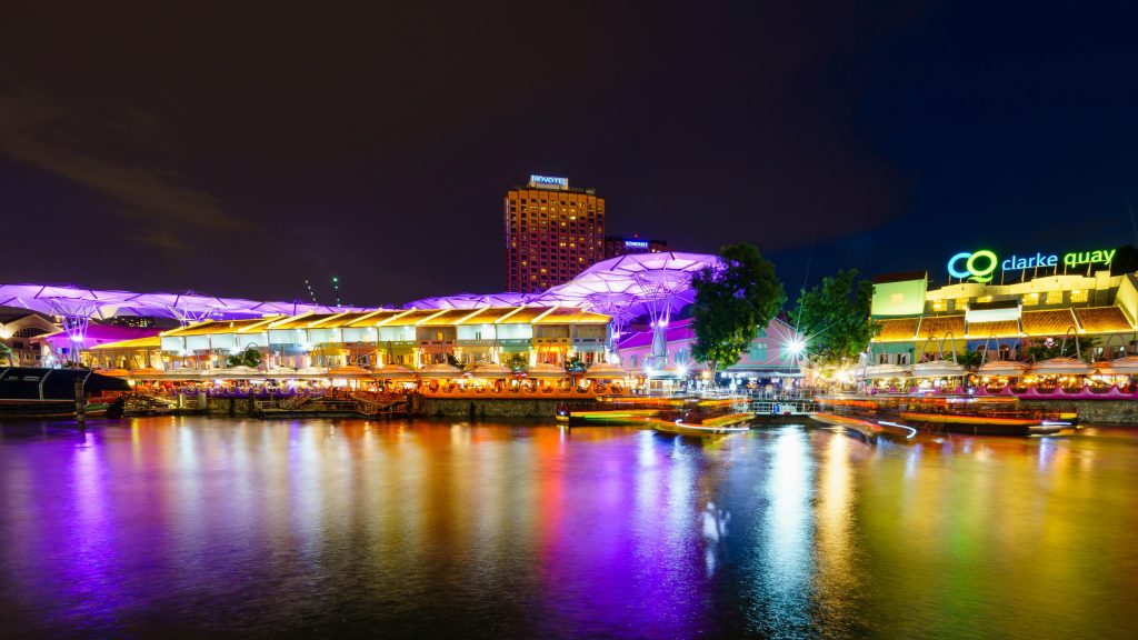 Illuminated waterfront view of Clarke Quay in Singapore during night time.